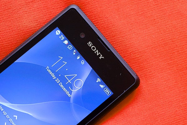 Sony Xperia E3 smartphone on a red background.