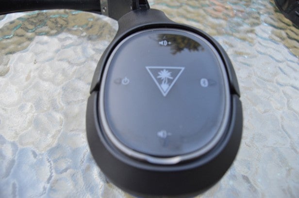 Turtle Beach Elite 800 wireless gaming headset on glass table.Close-up of Turtle Beach Elite 800 headset's ear cup.