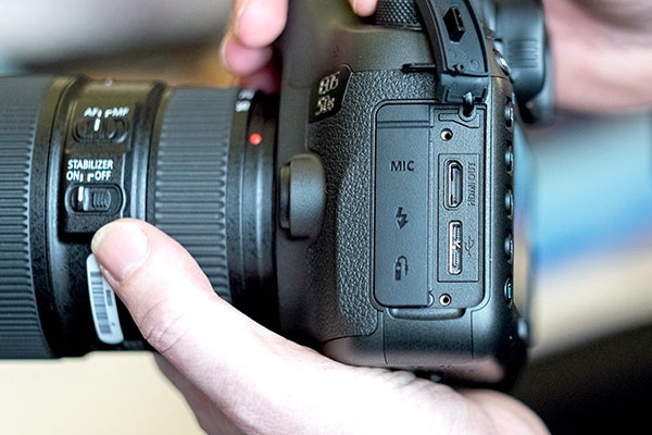 Hands holding a Canon EOS 5DS DSLR camera.Hands holding a Canon EOS 5DS camera with lens.Hand adjusting settings on Canon EOS 5DS camera.Close-up of Canon EOS 5DS camera settings screenCanon EOS 5DS DSLR camera with red-ringed lens held in hand.Canon EOS 5DS camera with settings displayed on LCD screen