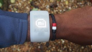 Person wearing Adidas MiCoach Fit Smart wristband.