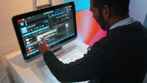 Person using HP Sprout computer's touchscreen interface.