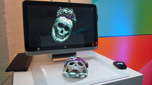 Person using HP Sprout computer with DJ interface application.Person interacting with HP Sprout computer's touch screen.Man using HP Sprout computer with touch screen interface.HP Sprout computer scanning a decorative skull.HP Sprout computer scanning a decorated skull into digital 3D model.Hand holding HP Sprout's stylus with screen interface in background.