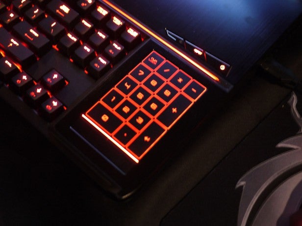 Illuminated gaming keyboard and trackpad close-up.