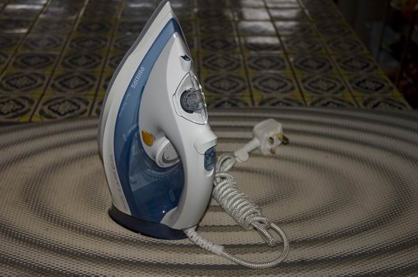 Philips Azur Performer steam iron on ironing board.
