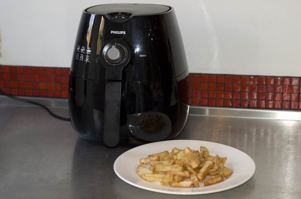 Philips Viva Airfryer HD9220 with a plate of fries beside it.