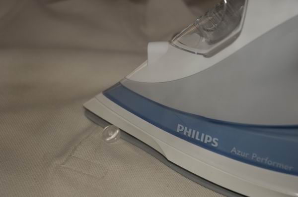 Close-up of Philips Azur Performer iron on fabric.