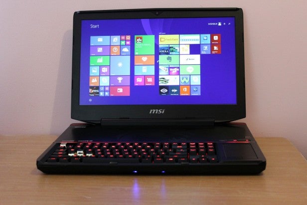 MSI GT80 gaming laptop with illuminated keyboard on desk.