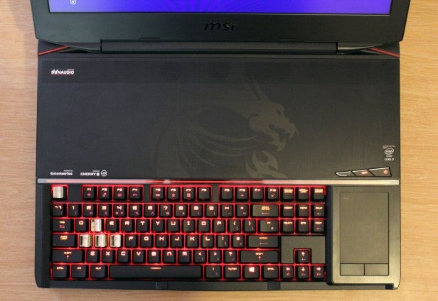 Gaming laptop with red-backlit keyboard and integrated trackpad.