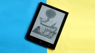 Cybook Ocean e-reader displaying artwork on split blue-yellow background.