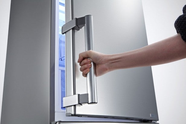 Person opening LG GBB530NSCFE fridge freezer door