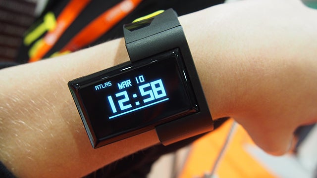 Atlas Wristband fitness tracker on a user's wrist displaying time.