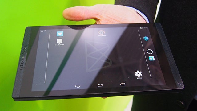 Hand holding a Blackphone+ tablet displaying the home screen.