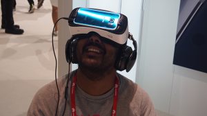 Man experiencing virtual reality with Samsung Gear VR headset.