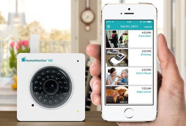 Y-cam HomeMonitor HD camera beside smartphone app interface.