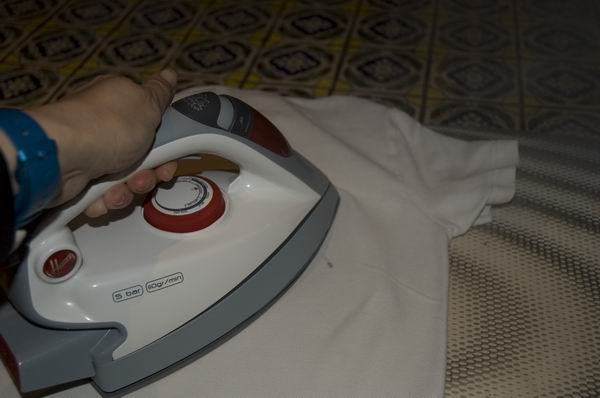 Person ironing a shirt with a Hoover IronSpeed SRD 4110/2.
