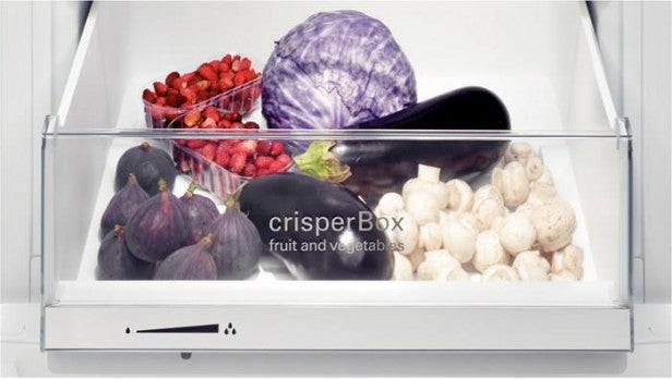 Siemens refrigerator crisper drawer filled with fresh fruits and vegetables.
