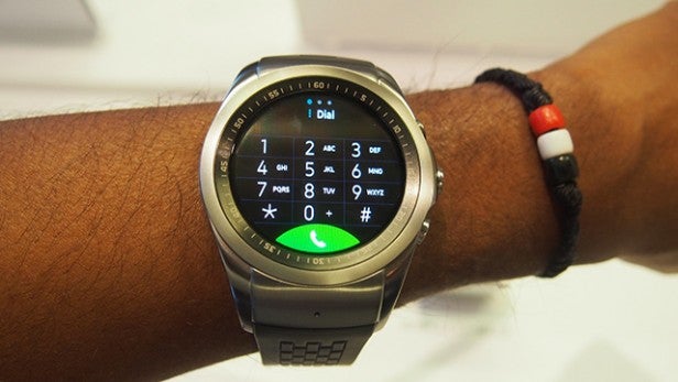 LG Watch Urbane LTE on wrist with dial pad display.LG Watch Urbane LTE on wrist with dial interface displayed.LG Watch Urbane LTE on person's wrist.Hand holding LG Watch Urbane LTE displaying software information
