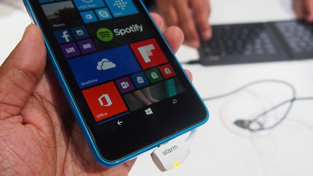 Hand holding a Microsoft Lumia 640 smartphone with screen visible.