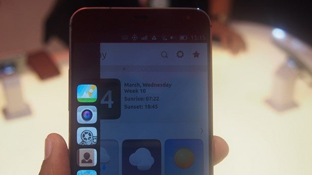 Meizu MX4 Ubuntu Edition smartphone displaying home screen.