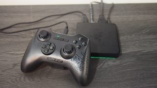Razer Forge TV and controller on a wooden surface.