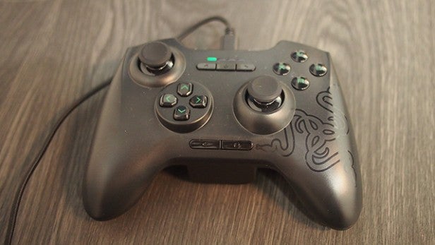 Razer Forge TV game controller on a wooden surface.Razer Forge TV controller on wooden surface.