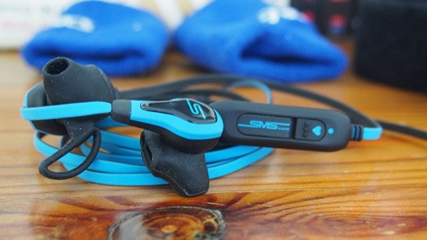 SMS Audio BioSport earbuds with heart rate monitor on table.
