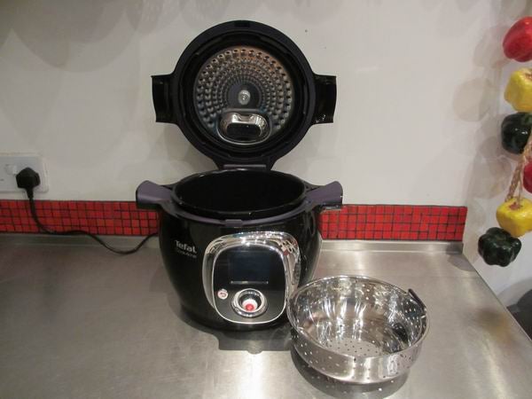 Tefal Cook4Me pressure cooker with open lid and steamer basket.