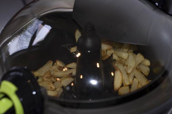 Fries cooking inside Tefal ActiFry Express XL Air Fryer.