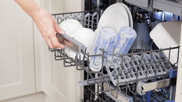 Person loading dishes into a modern dishwasher