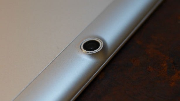 Close-up of laptop's audio jack on metallic surface.