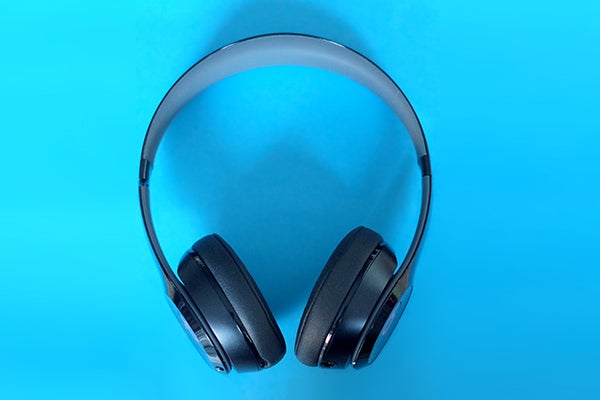 Beats Solo 2 Wireless headphones on a blue background.