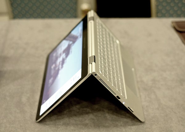 HP Spectre x360 laptop in tent mode on a table.