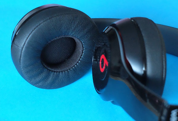 Close-up of Beats Solo 2 Wireless Headphones on blue background.