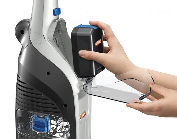 Person inserting battery into Vax Floormate Cordless Cleaner.