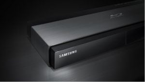Samsung BD-J7500 Blu-ray player on a dark surface.