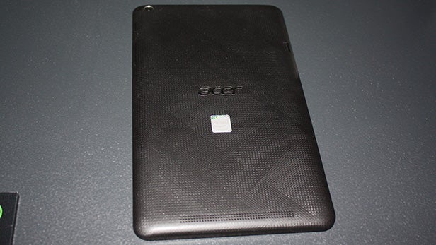 Acer Iconia One 8 tablet back view on a dark surface.