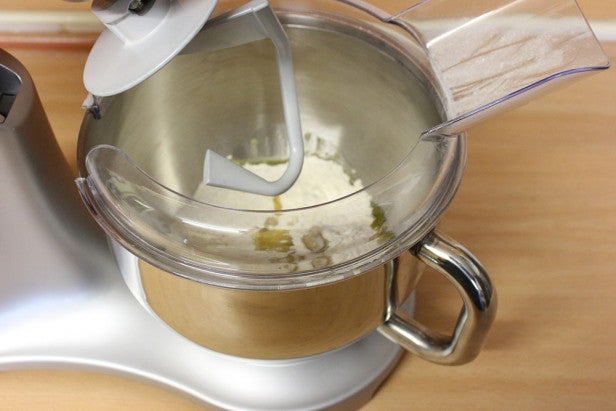 Smeg stand mixer in use with ingredients in bowl.