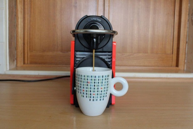 Magimix Nespresso Pixie machine dispensing coffee into cup.