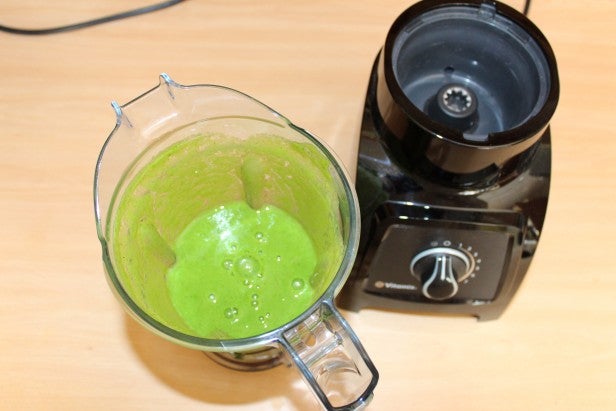 Vitamix S30 blender with green smoothie on kitchen counter.