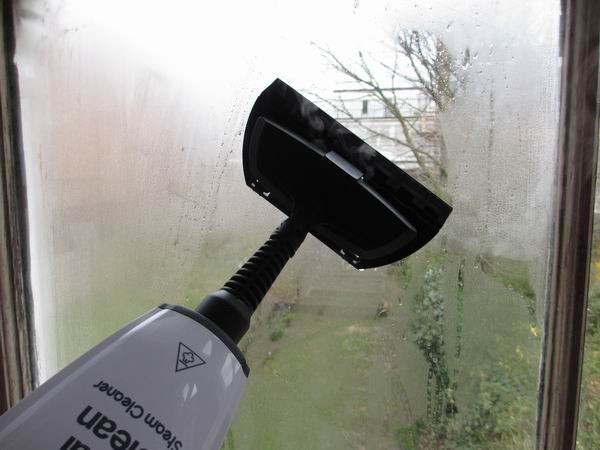 Morphy Richards steam cleaner being used on a window.