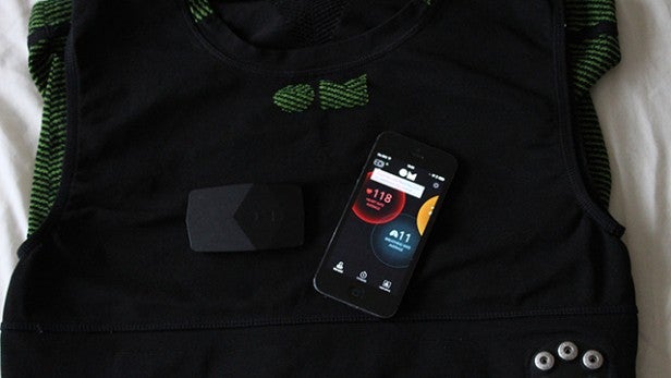 OMSignal shirt with attached module and smartphone displaying fitness app