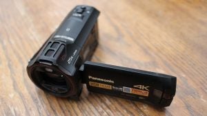 Panasonic HC-WX970 4K camcorder on wooden surface.