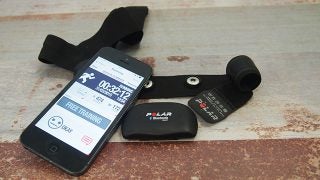 Polar H7 heart rate sensor with strap and smartphone app display.