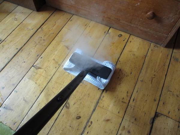Polti Vaporetto Airplus steam cleaner in use on wooden floor.