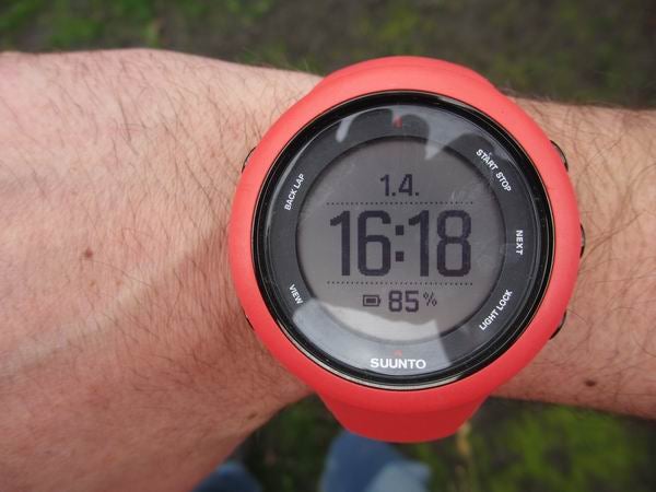 Suunto Ambit3 Sport watch on wrist displaying time and heart rate.