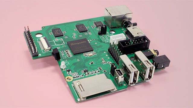 Creator CI20 computer board on a pink background.