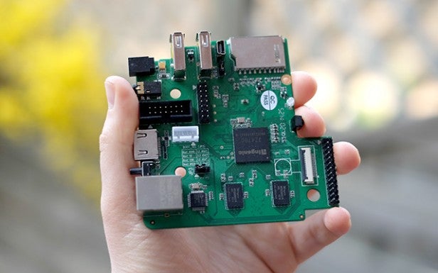 Hand holding a single-board computer with electronic components