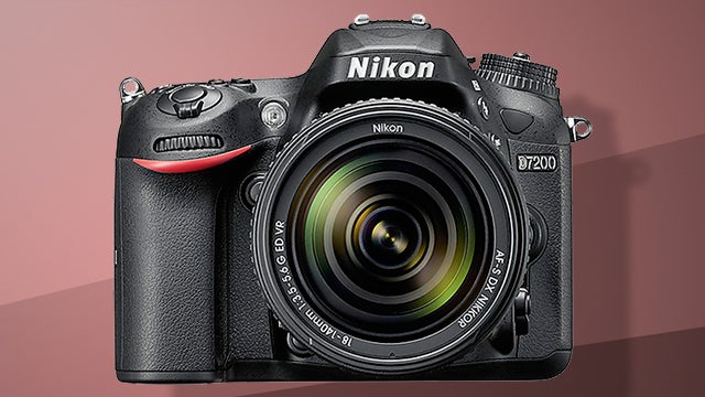 Nikon D7200 DSLR camera with lens on pink background