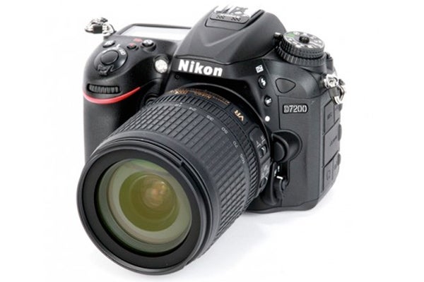 Nikon D7200 DSLR camera with lens on white background.