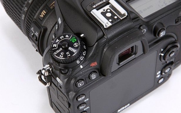 Close-up of a DSLR camera's control dial and buttons.